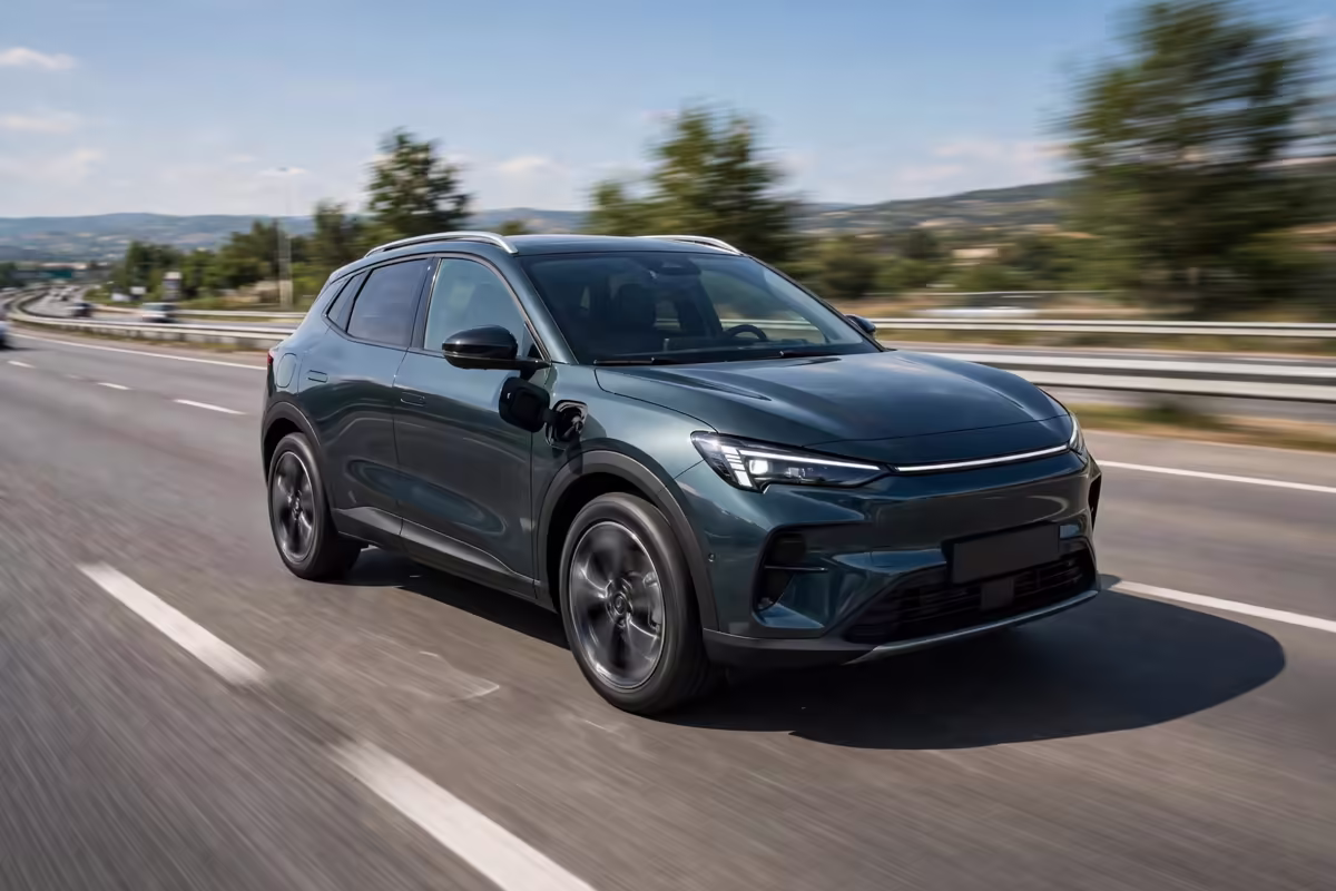 Plug-in hybrid compact SUV driving on a highway at speed.